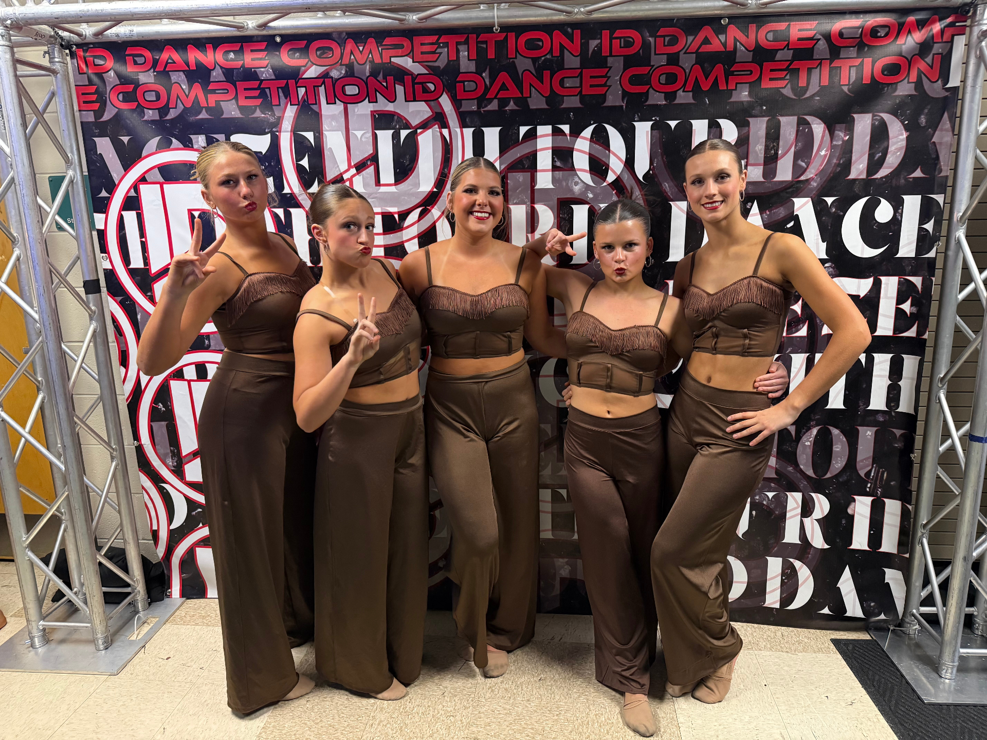 Team backstage in brown fringe