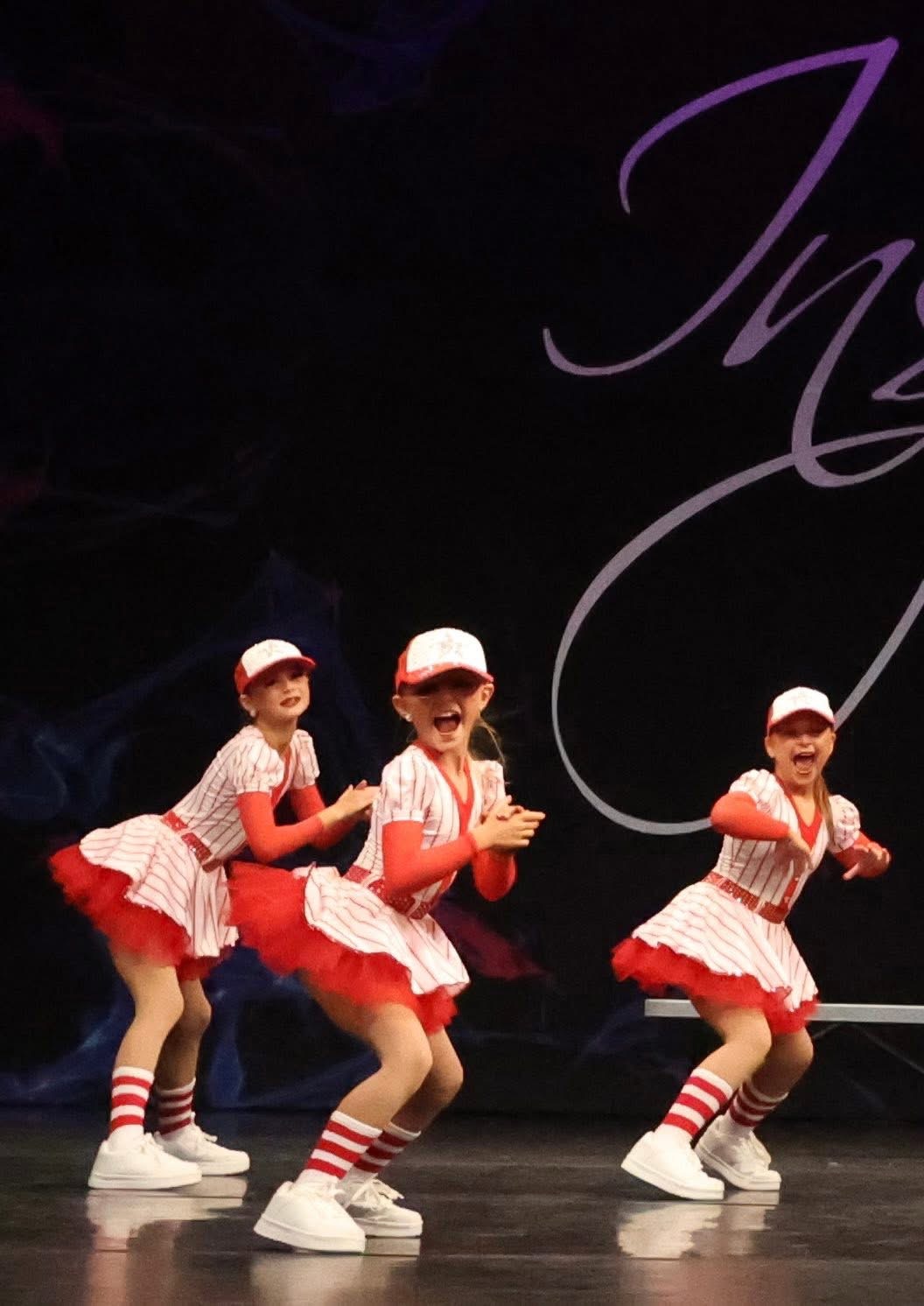 Mini trio in baseball costumes on stage