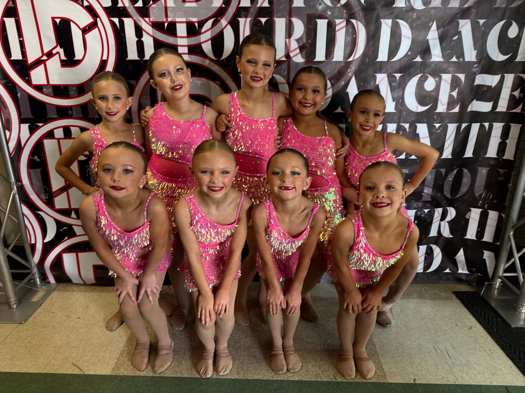 Mini team in pink sequin costumes