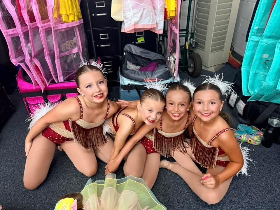 Dancers backstage in red fringe